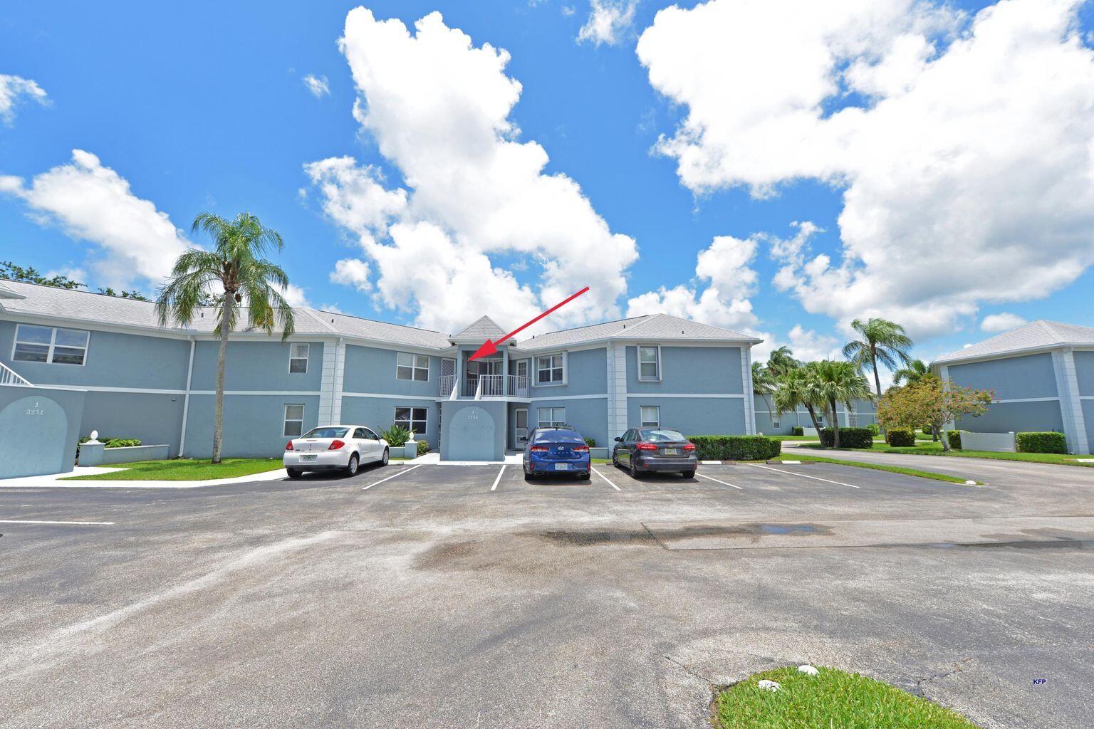 3254 Southeast Aster Lane, Unit 239 Stuart, FL 34994 - Photo 22 of 24 a view of a parked cars in front of a building