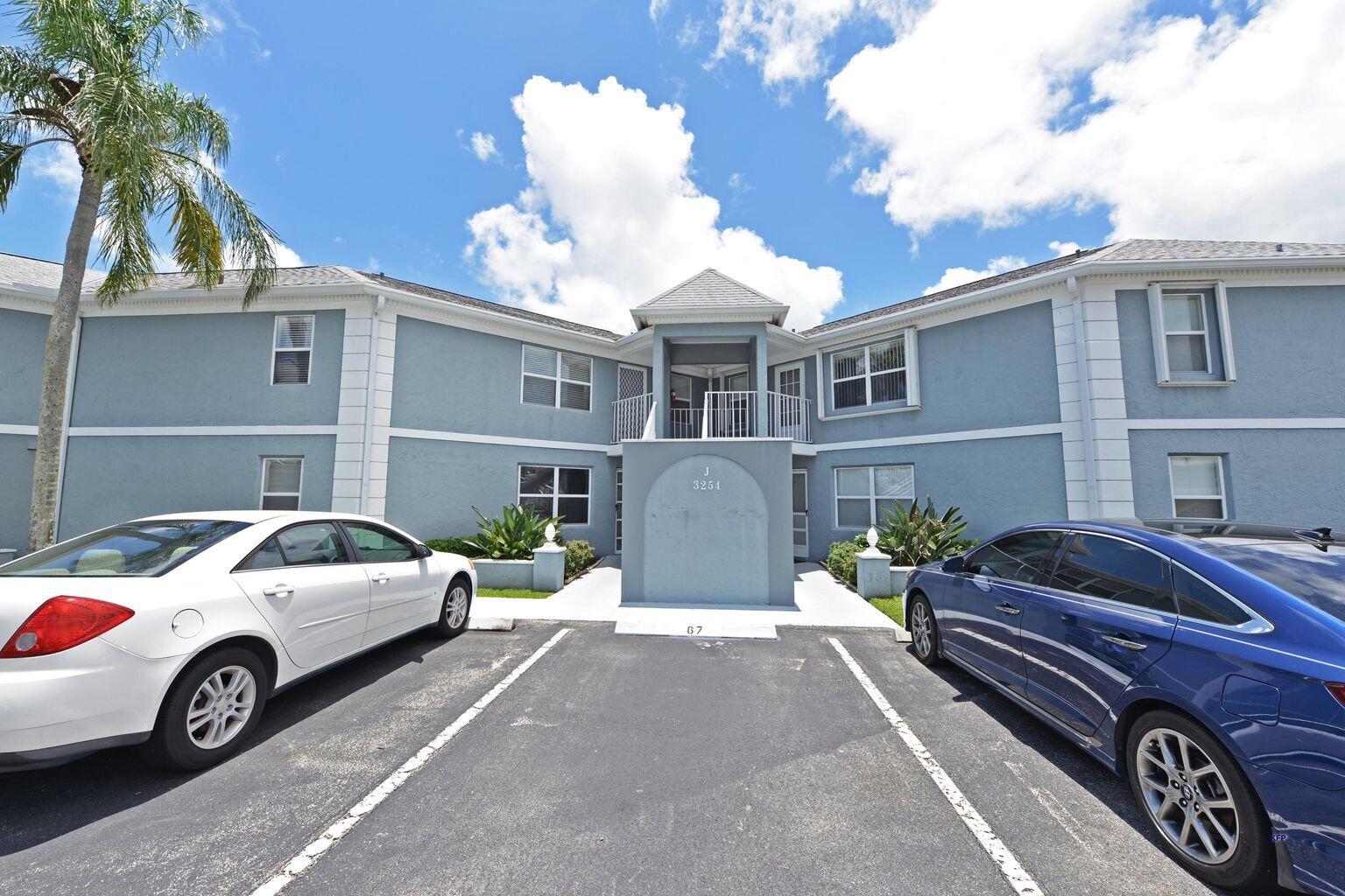 3254 Southeast Aster Lane, Unit 239 Stuart, FL 34994 - Photo 23 of 24 a front view of a house with parking space
