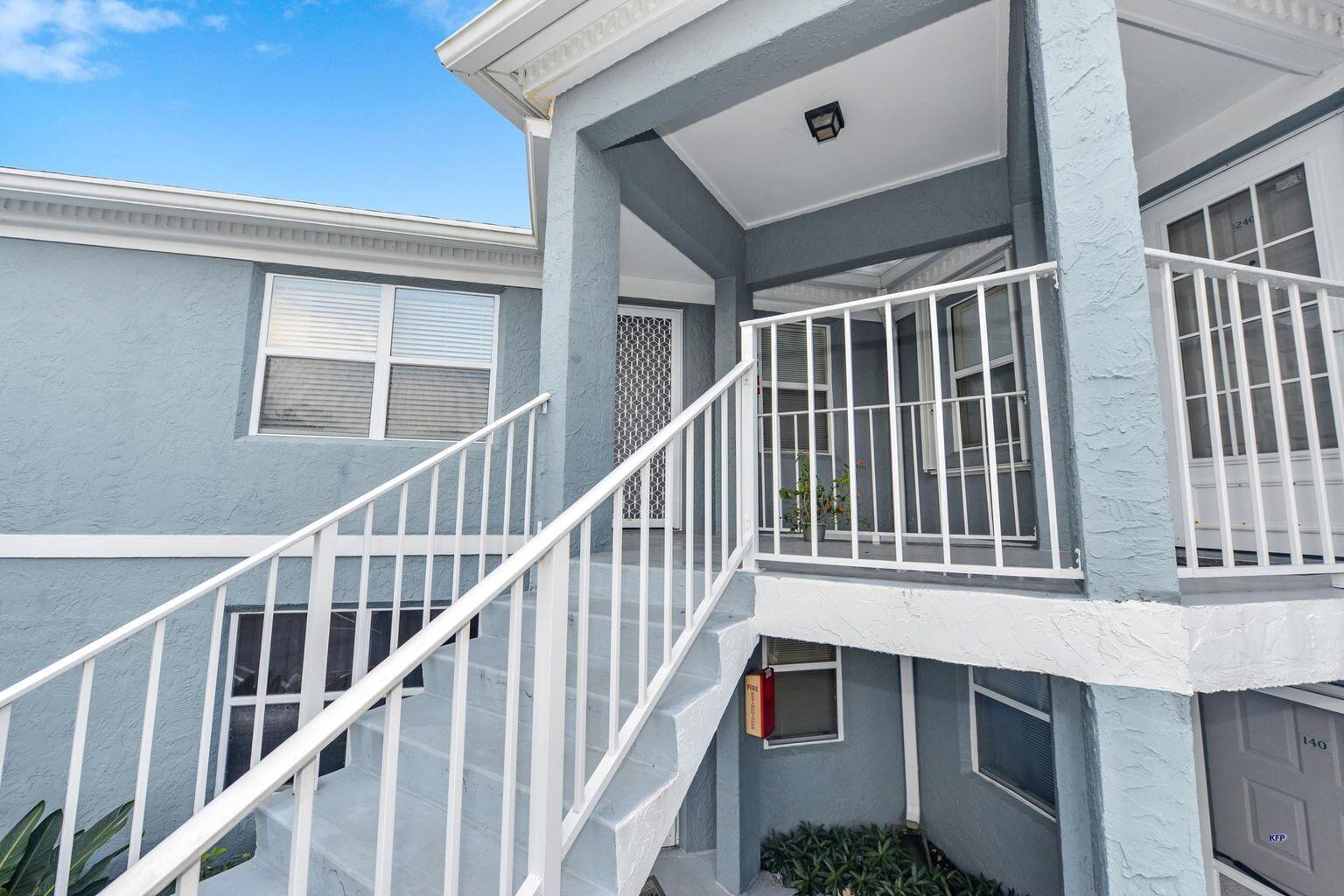 3254 Southeast Aster Lane, Unit 239 Stuart, FL 34994 - Photo 3 of 24 a view of staircase with white walls and windows