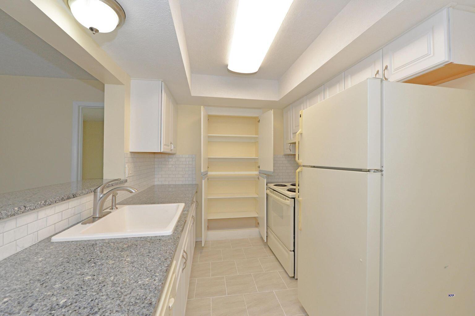 3254 Southeast Aster Lane, Unit 239 Stuart, FL 34994 - Photo 8 of 24 a bathroom with a granite countertop sink and a mirror