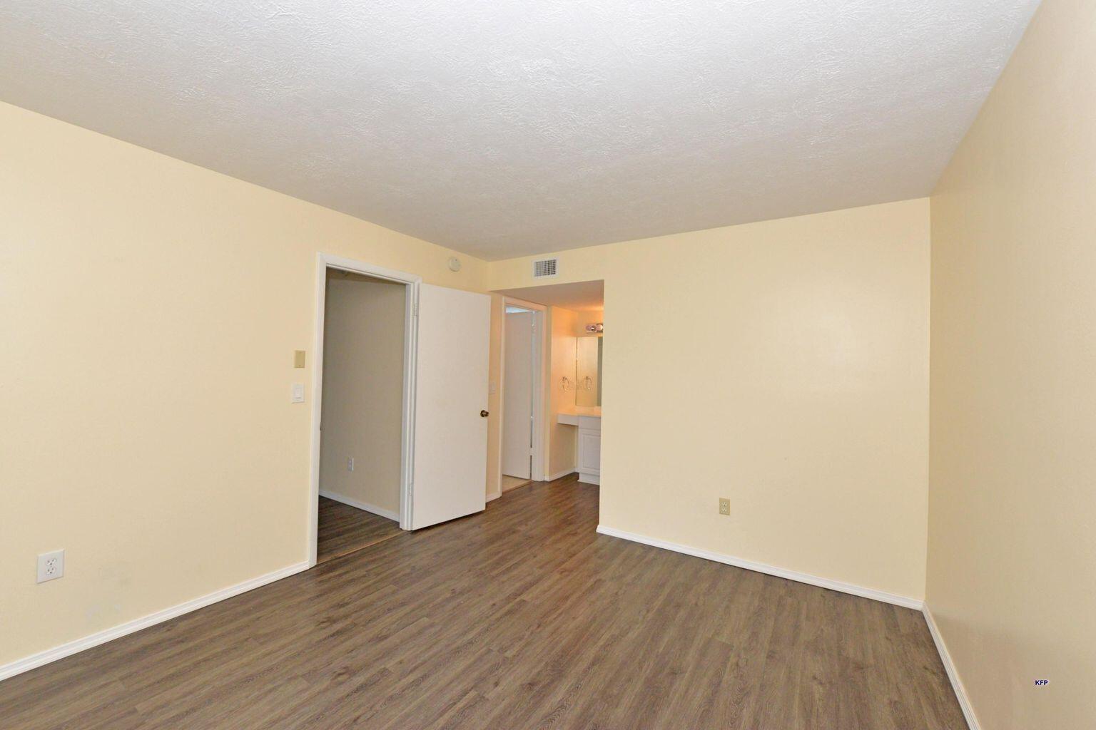 3254 Southeast Aster Lane, Unit 239 Stuart, FL 34994 - Photo 10 of 24 a view of an empty room with wooden floor