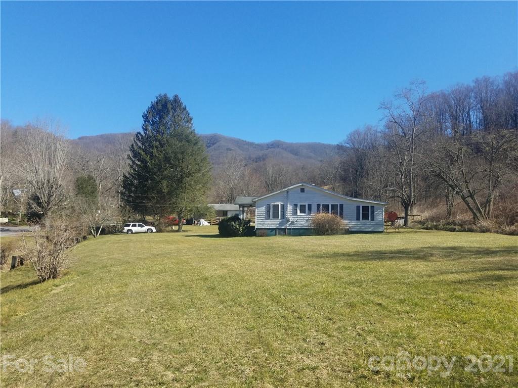 1118 Camp Branch Road Waynesville, NC 28786 - Photo 2 of 30 a view of a big yard with a house in the background