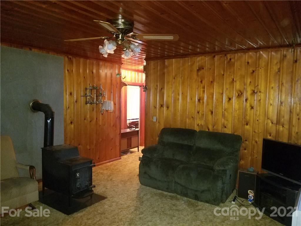 1118 Camp Branch Road Waynesville, NC 28786 - Photo 12 of 30 a living room with furniture and a flat screen tv