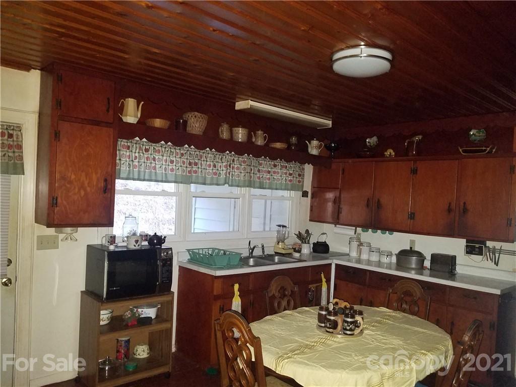 1118 Camp Branch Road Waynesville, NC 28786 - Photo 16 of 30 a kitchen with a sink appliances and cabinets
