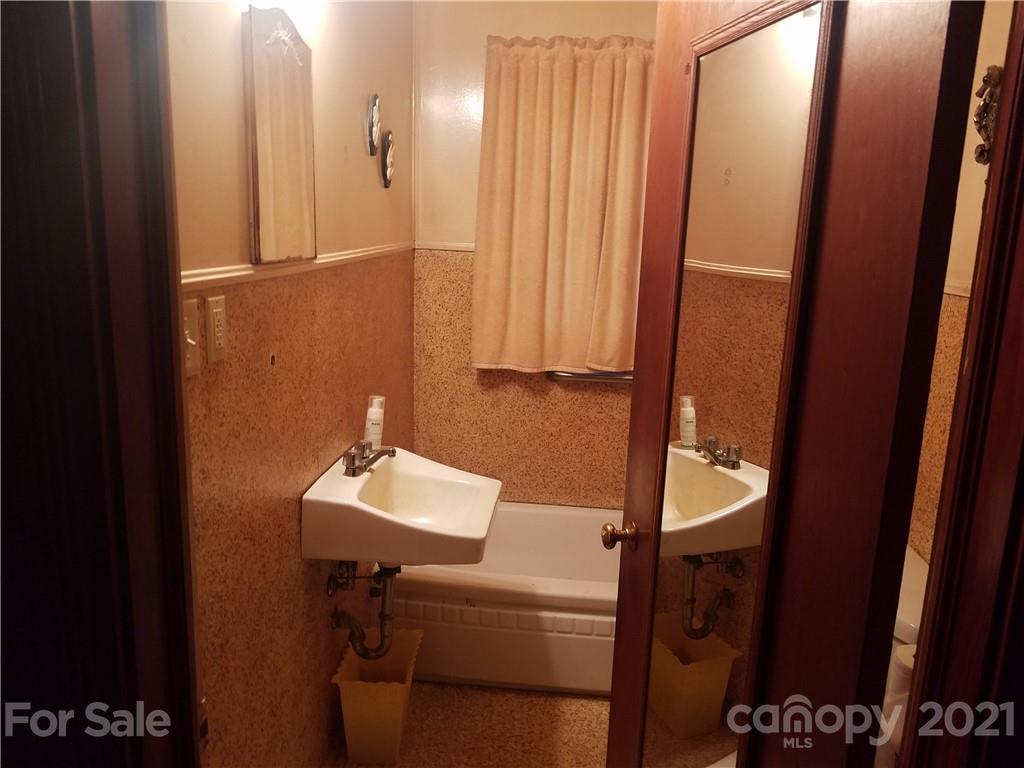 1118 Camp Branch Road Waynesville, NC 28786 - Photo 19 of 30 a bathroom with a sink a mirror and shower