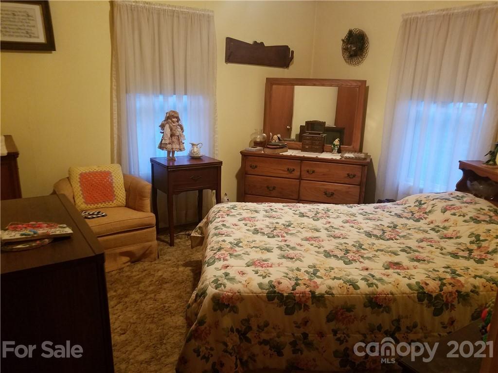 1118 Camp Branch Road Waynesville, NC 28786 - Photo 20 of 30 a bedroom with a bed and dresser