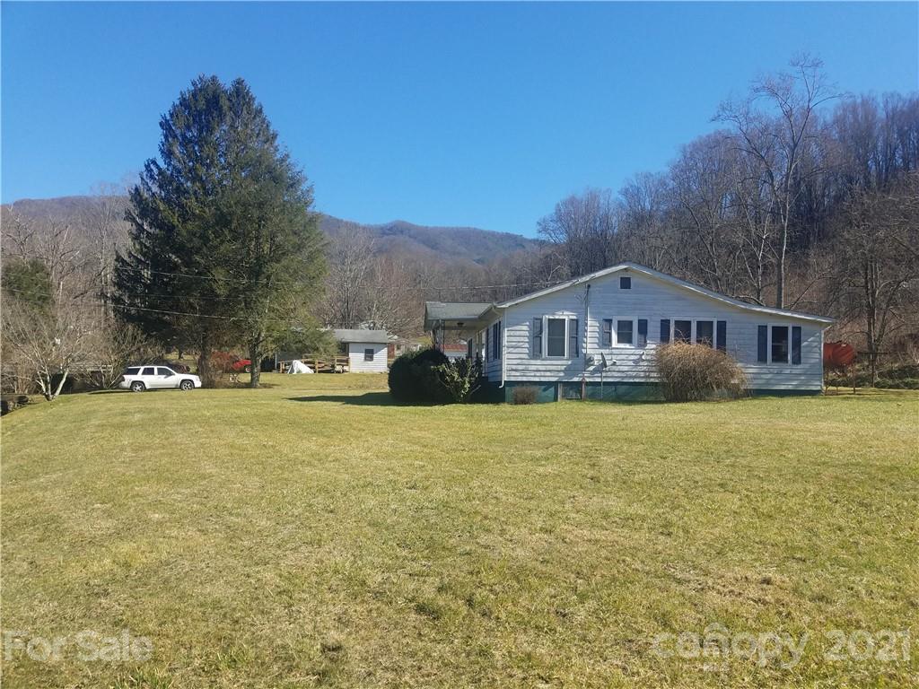 1118 Camp Branch Road Waynesville, NC 28786 - Photo 3 of 30 a front view of house with yard and trees in the background