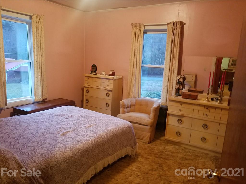 1118 Camp Branch Road Waynesville, NC 28786 - Photo 23 of 30 a bedroom with a bed and furniture