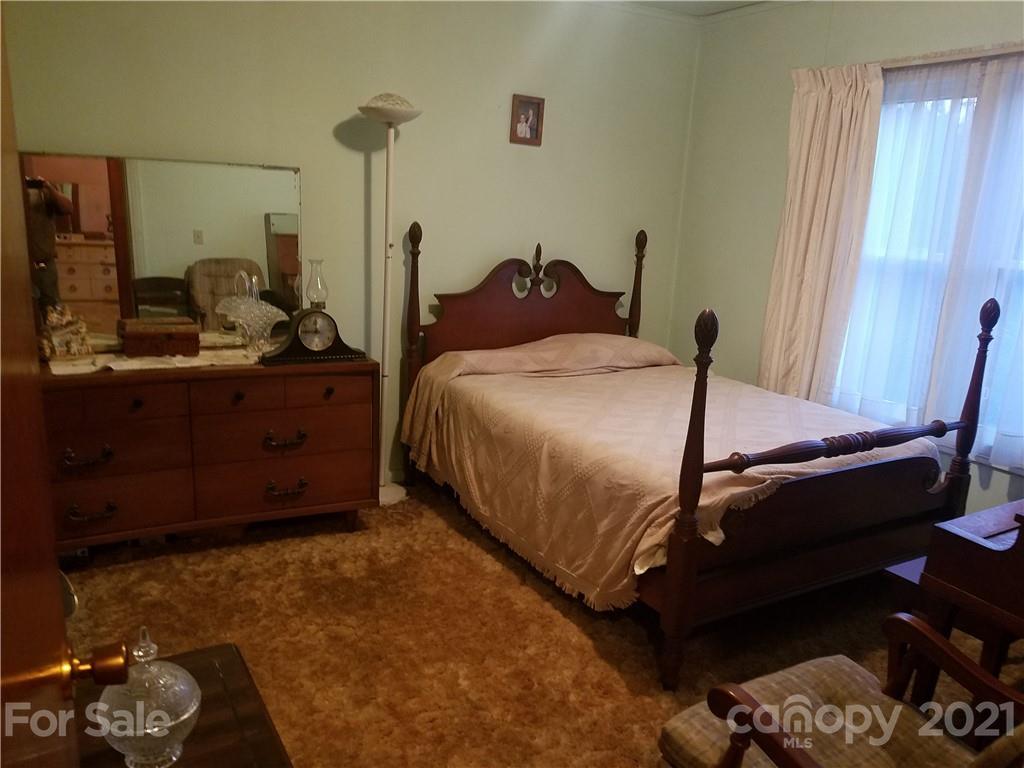 1118 Camp Branch Road Waynesville, NC 28786 - Photo 24 of 30 a bedroom with a bed and a dresser