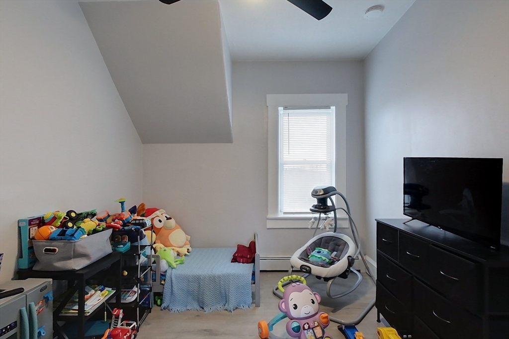 6 Kendall Street Methuen, MA 01844 - Photo 11 of 42 a bedroom with furniture and a flat screen tv