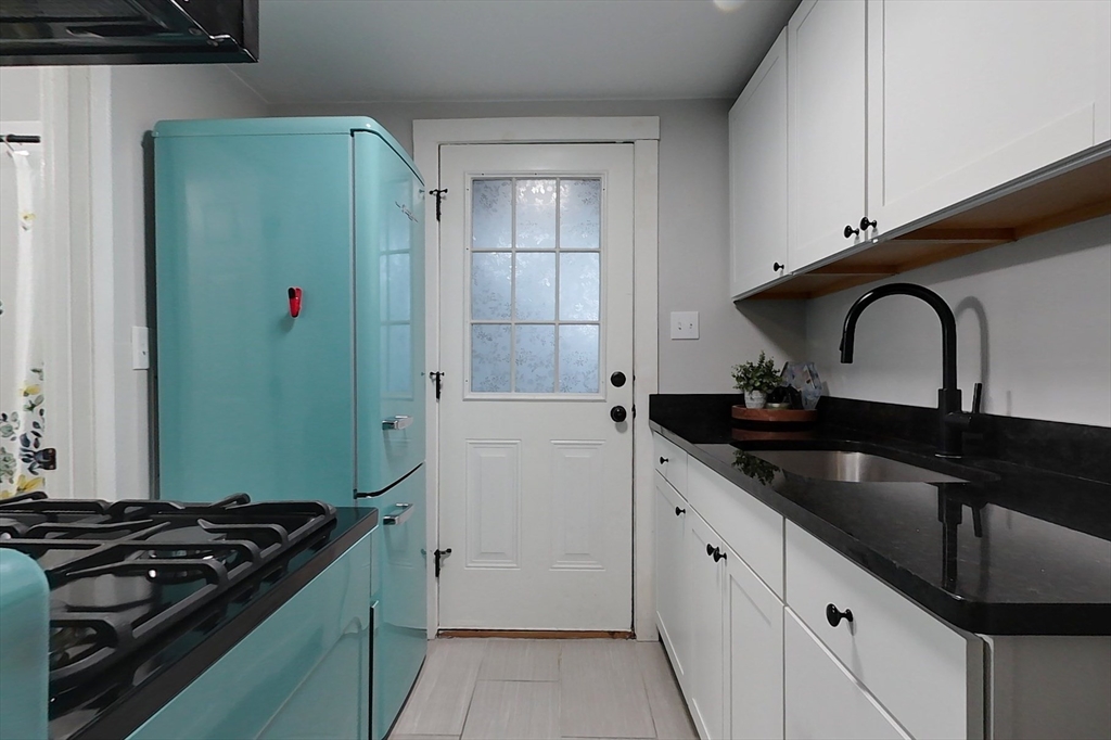 6 Kendall Street Methuen, MA 01844 - Photo 13 of 42 a kitchen with stainless steel appliances granite countertop a sink stove and refrigerator