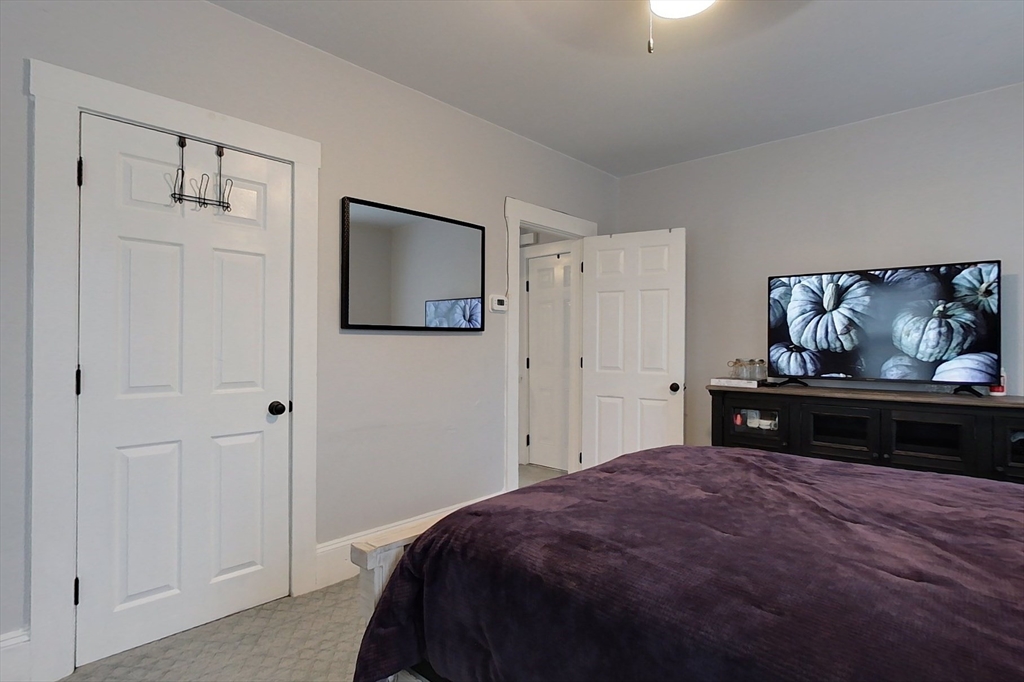 6 Kendall Street Methuen, MA 01844 - Photo 19 of 42 a bedroom with a bed and painting on the wall