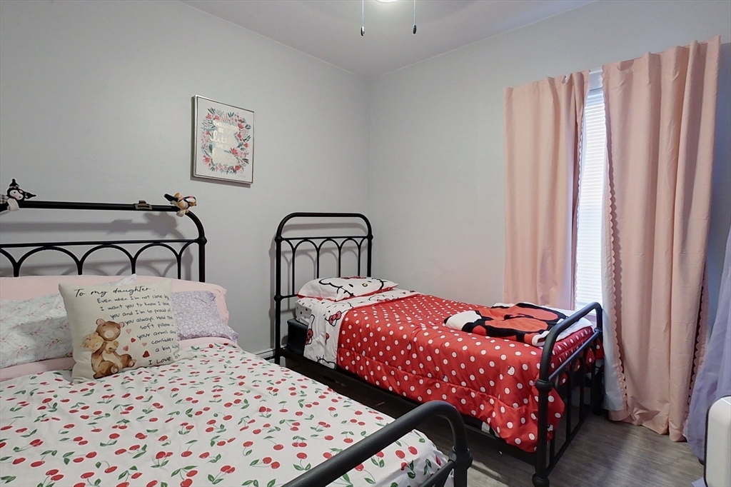 6 Kendall Street Methuen, MA 01844 - Photo 21 of 42 a bedroom with two beds and a curtain