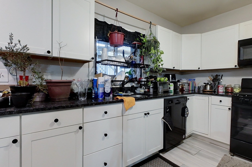 6 Kendall Street Methuen, MA 01844 - Photo 25 of 42 a kitchen with white cabinets and appliances