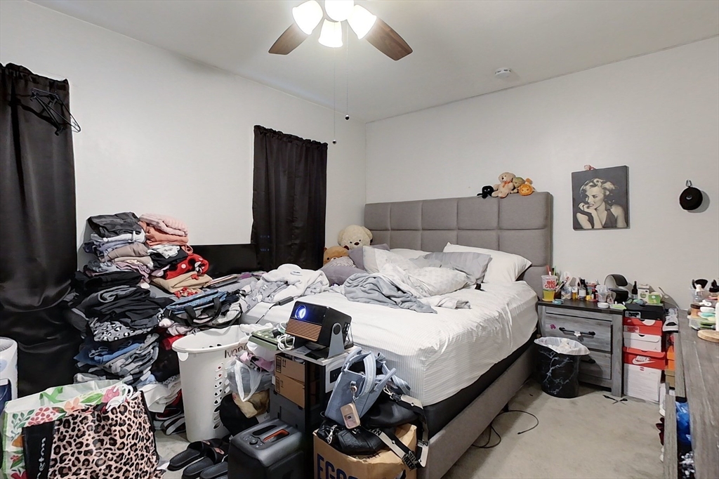 6 Kendall Street Methuen, MA 01844 - Photo 30 of 42 a bed room with a bed and a chandelier