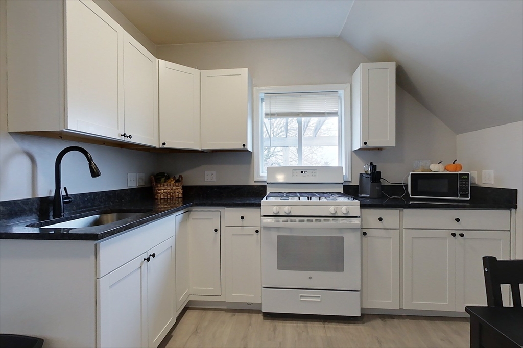 6 Kendall Street Methuen, MA 01844 - Photo 3 of 42 a kitchen with white cabinets and white appliances