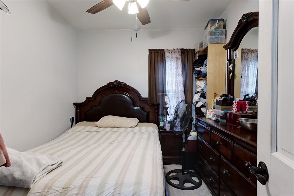 6 Kendall Street Methuen, MA 01844 - Photo 31 of 42 a bedroom with a bed and a chandelier