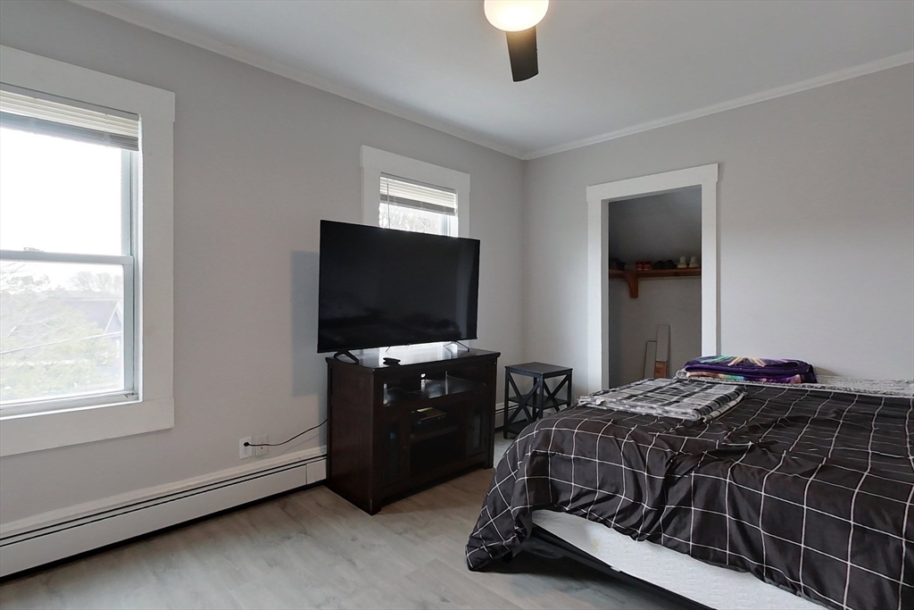 6 Kendall Street Methuen, MA 01844 - Photo 9 of 42 a bedroom with a bed and a flat tv screen on a dresser