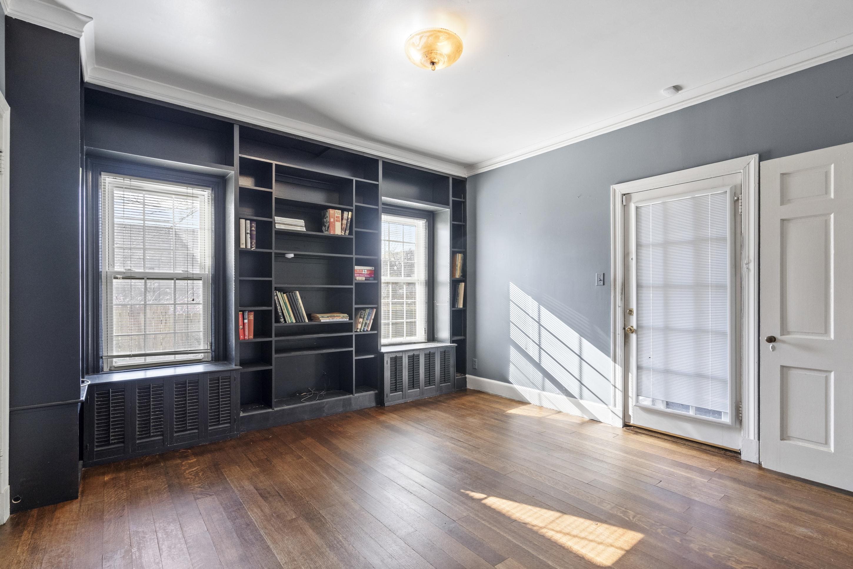 693 Holly Street Memphis, TN 38112 - Photo 15 of 32 an empty room with wooden floor and windows