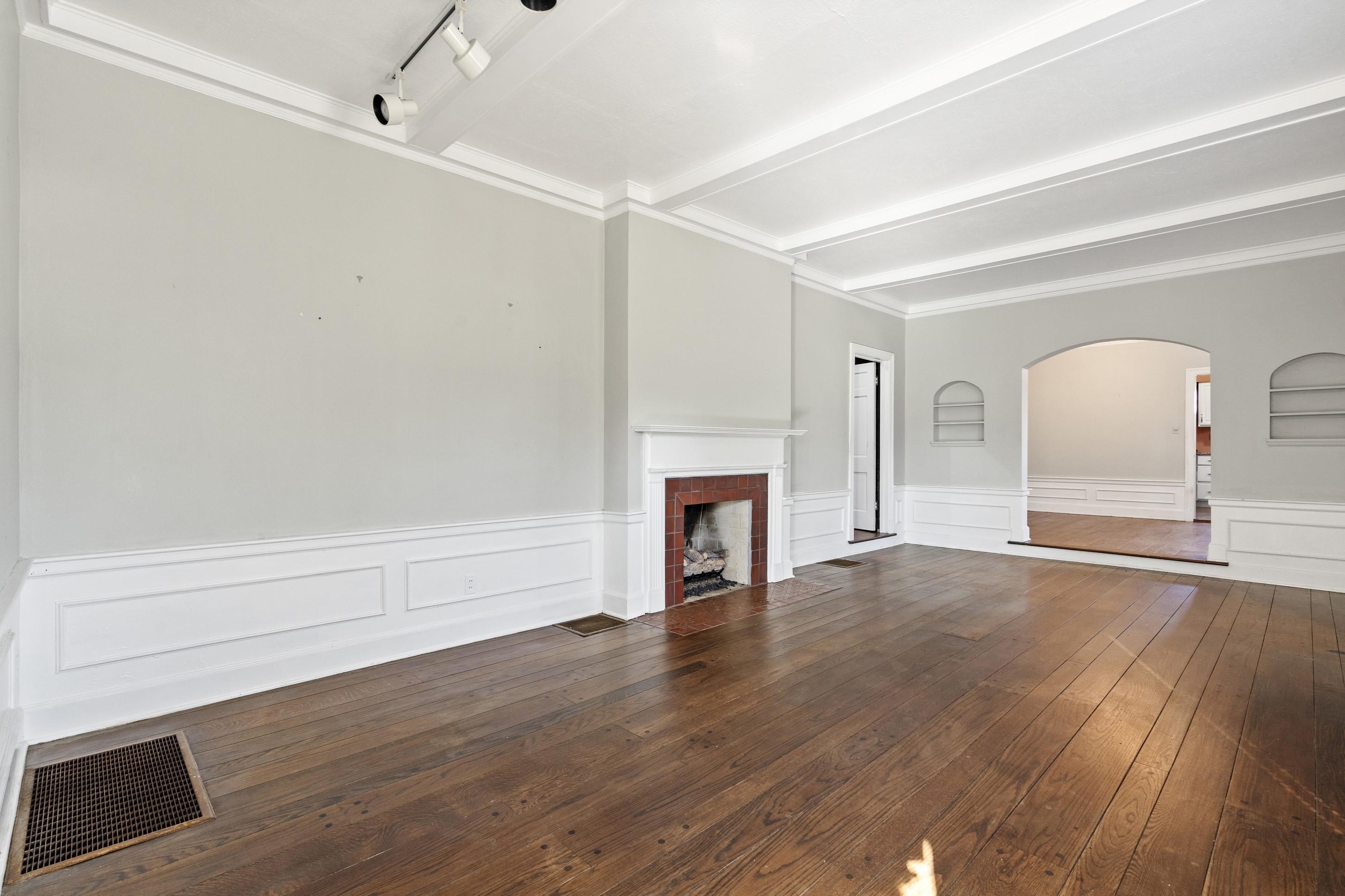 693 Holly Street Memphis, TN 38112 - Photo 5 of 32 a view of empty room with wooden floor and fireplace