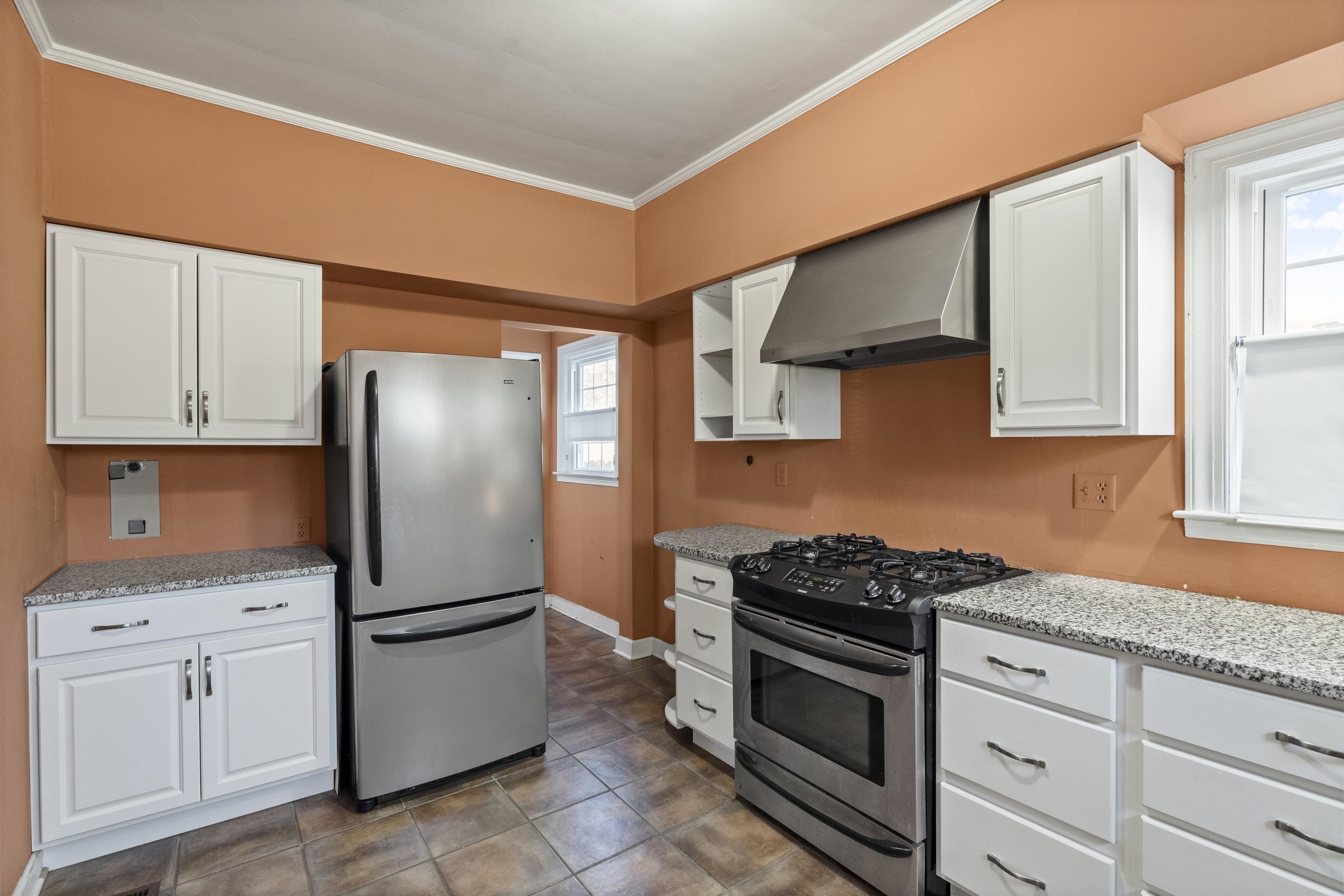 693 Holly Street Memphis, TN 38112 - Photo 8 of 32 a kitchen with appliances a sink and cabinets