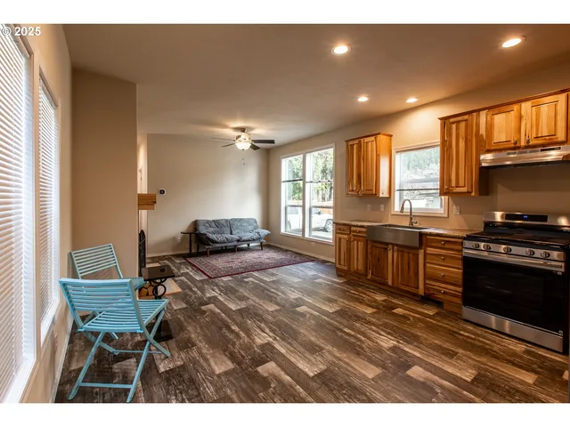 a open kitchen with sink and chairs