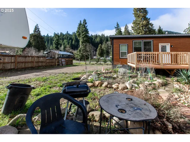 a view of a house with backyard and sitting area