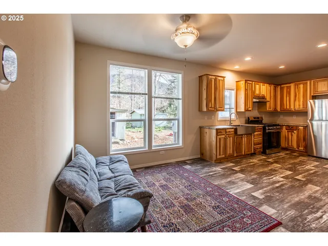 a living room with furniture a kitchen island dining table and chairs