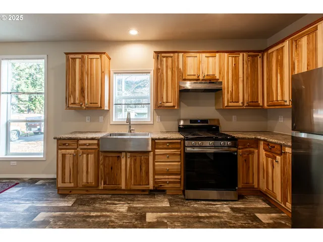 a kitchen with a stove a sink and a microwave