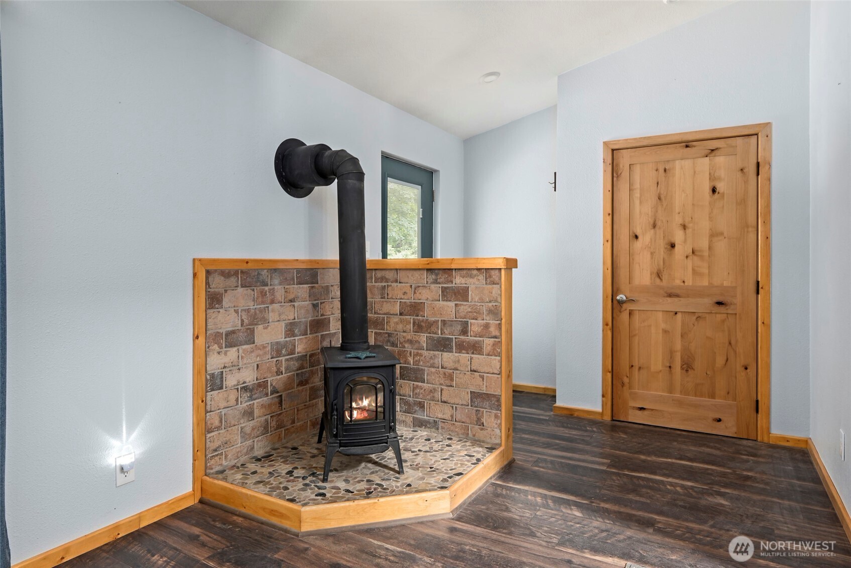 25451 Lake Cavanaugh Road Mount Vernon, WA 98274 - Photo 15 of 40 a view of fireplace and wooden floor