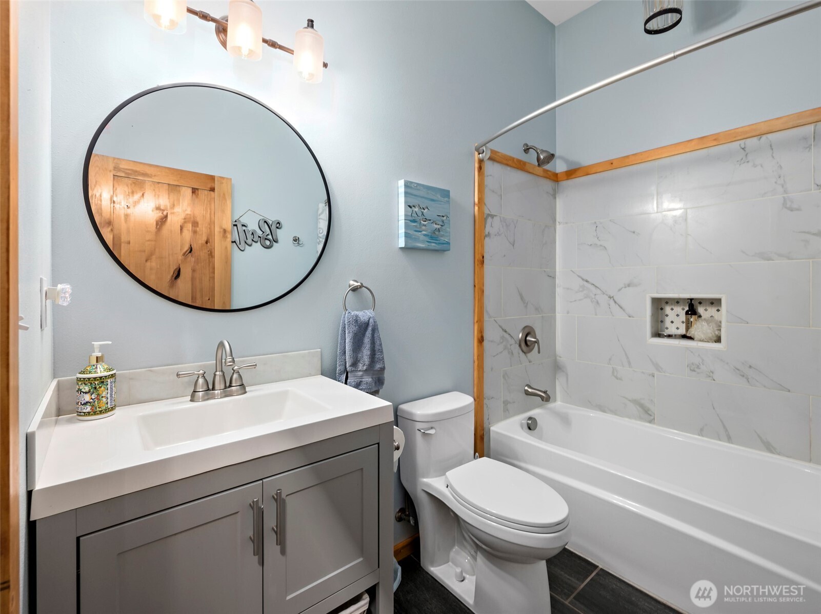 25451 Lake Cavanaugh Road Mount Vernon, WA 98274 - Photo 7 of 40 a bathroom with a sink a mirror a toilet and a shower