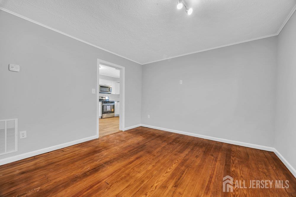 49 Comstock Street New Brunswick, NJ 08901 - Photo 12 of 20 a view of empty room with wooden floor