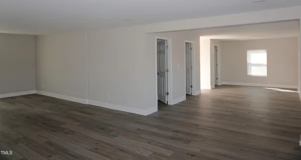 a view of a room with wooden floor and window