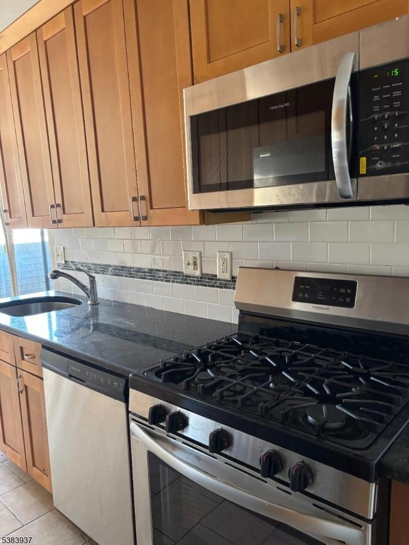 822 Main Street, Unit E Nutley, NJ 07110 - Photo 7 of 14 a stove top oven sitting inside of a kitchen