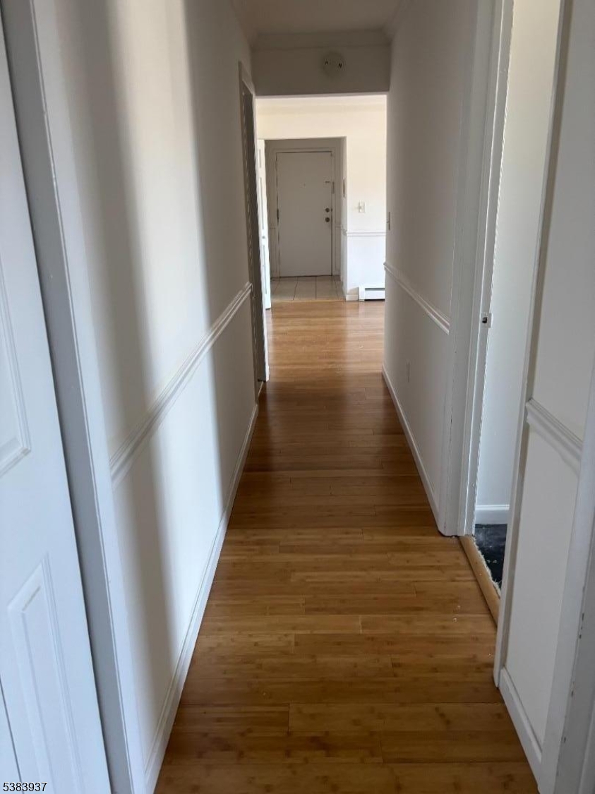 822 Main Street, Unit E Nutley, NJ 07110 - Photo 8 of 14 a view of a hallway with wooden floor