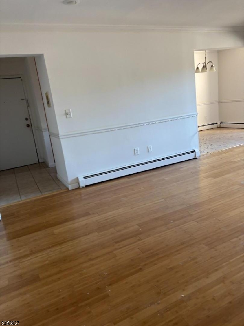 822 Main Street, Unit E Nutley, NJ 07110 - Photo 9 of 14 an empty room with wooden floor