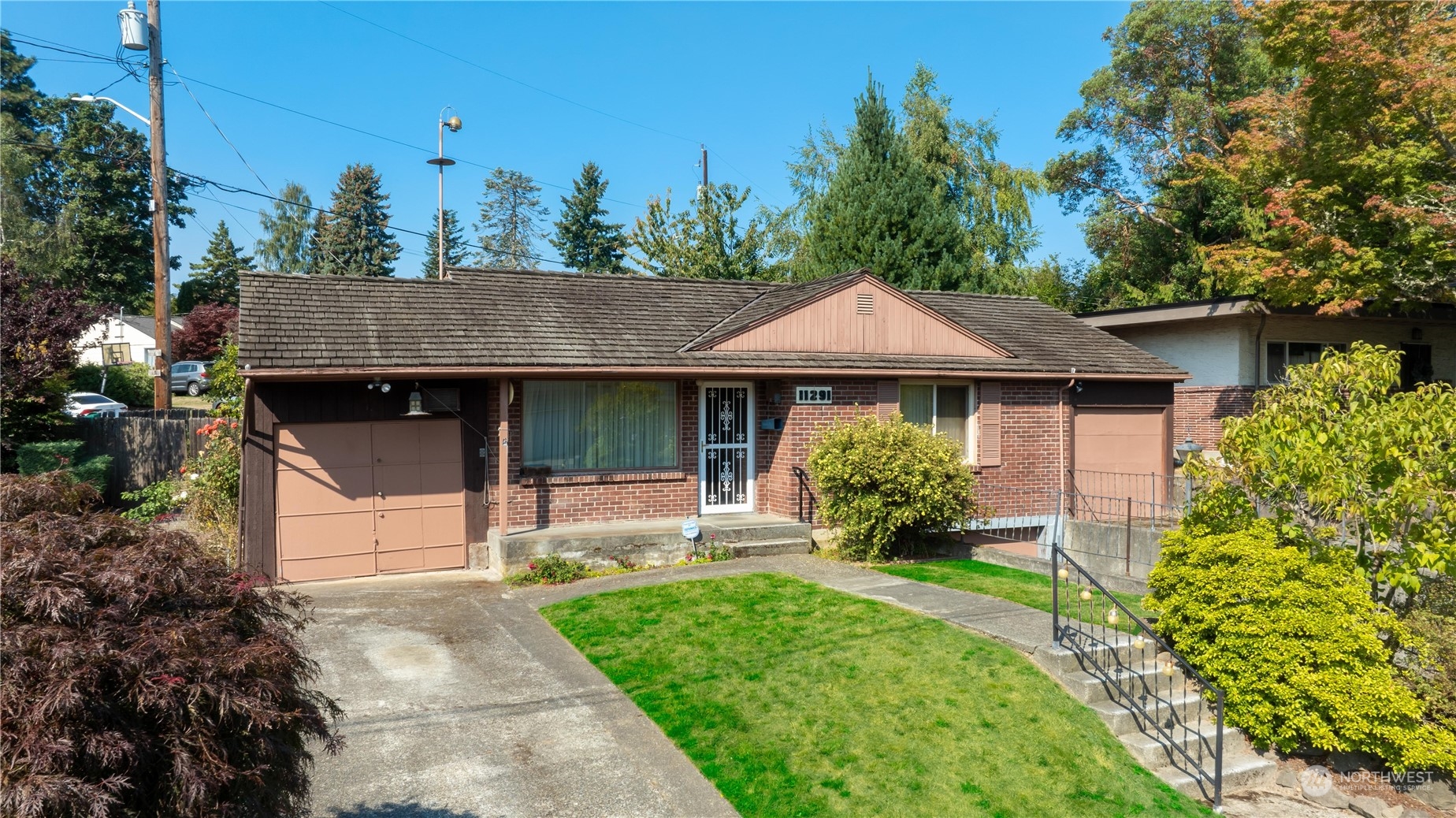 11291 35th Street Southwest Seattle, WA 98146 - Photo 1 of 1 a front view of a house with garden