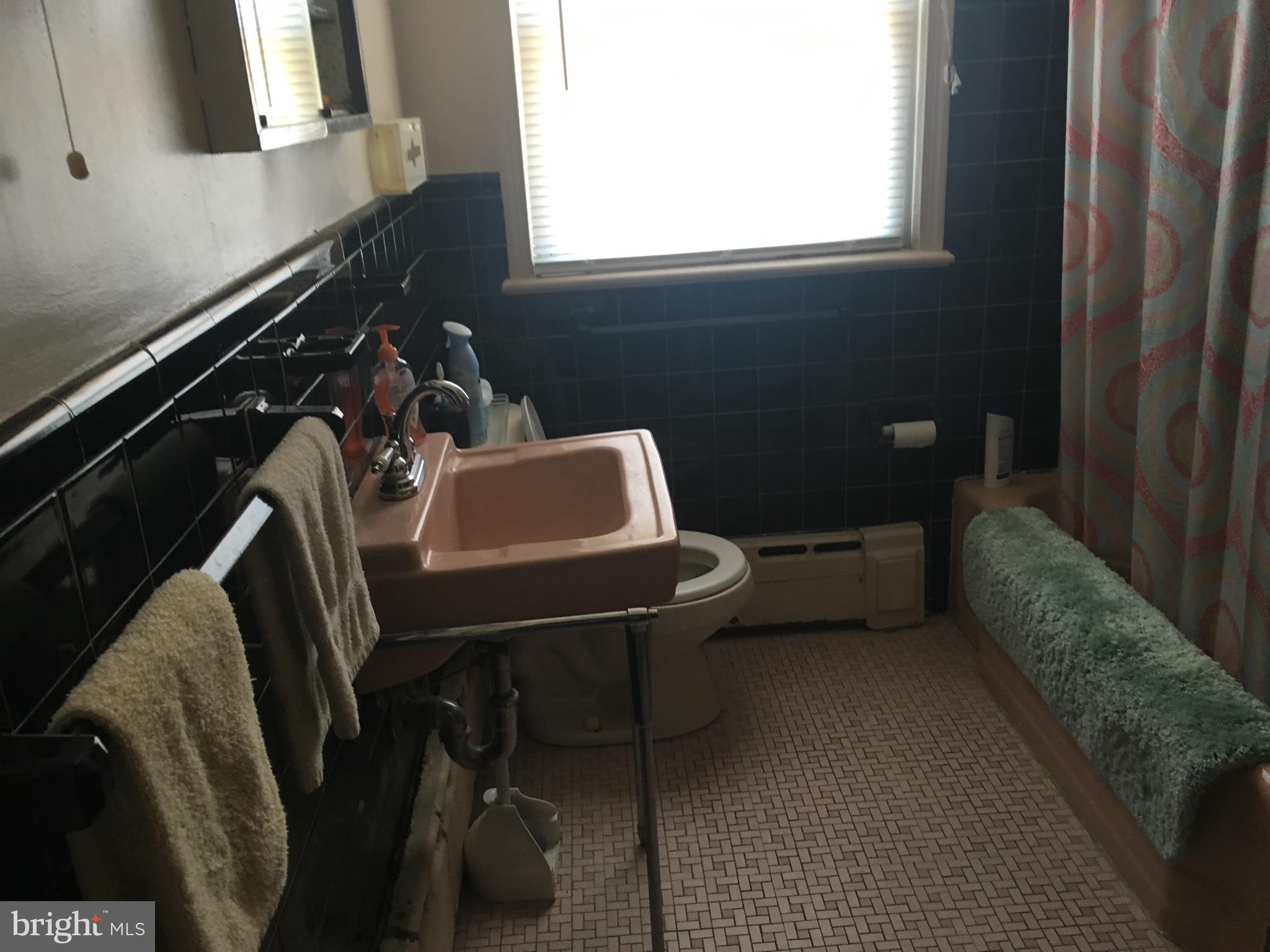 7300 Temple Hill Road Temple Hills, MD 20748 - Photo 9 of 14 a bathroom with a sink a toilet and mirror