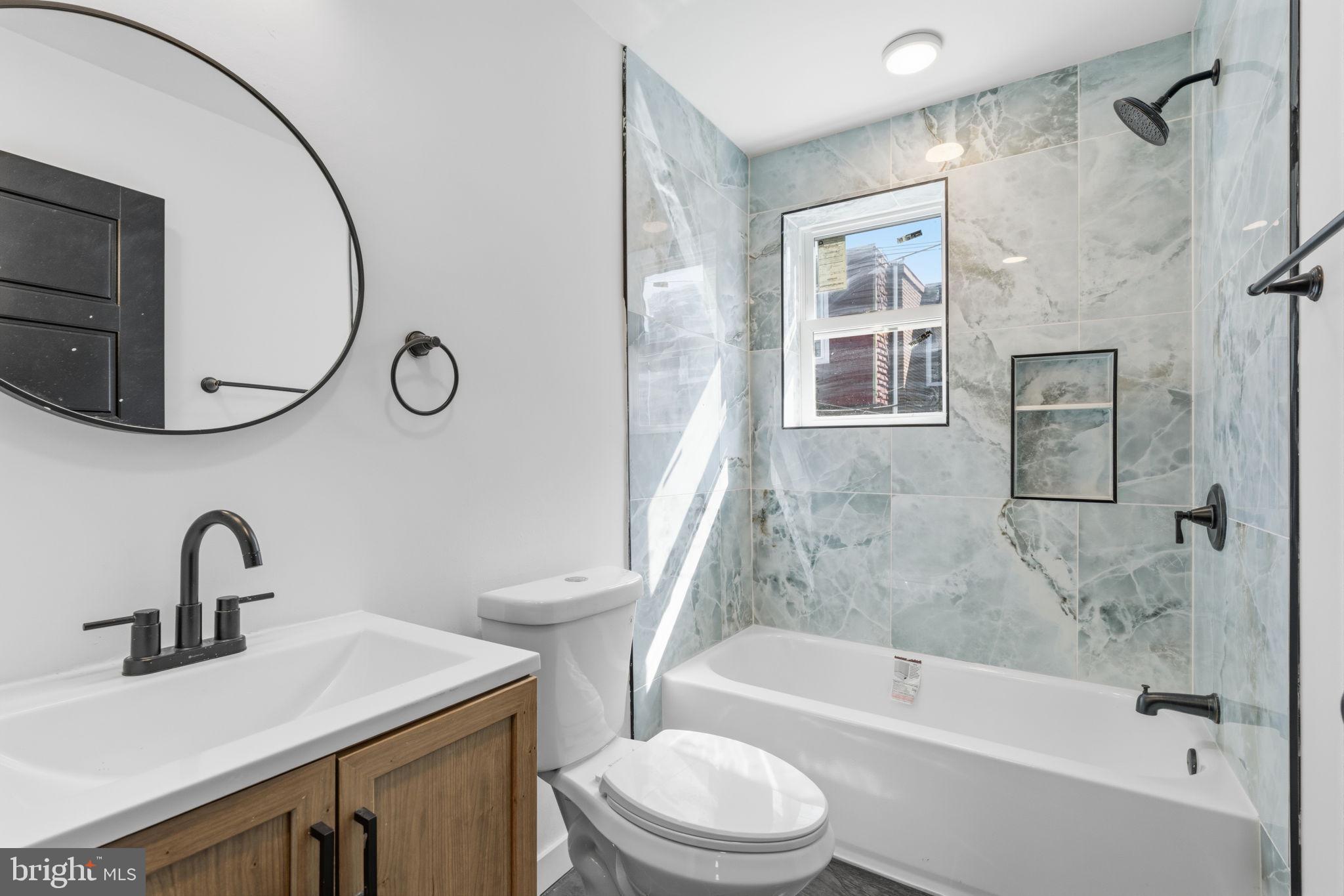 6508 Wheeler Street Philadelphia, PA 19142 - Photo 11 of 30 a bathroom with a sink toilet and shower