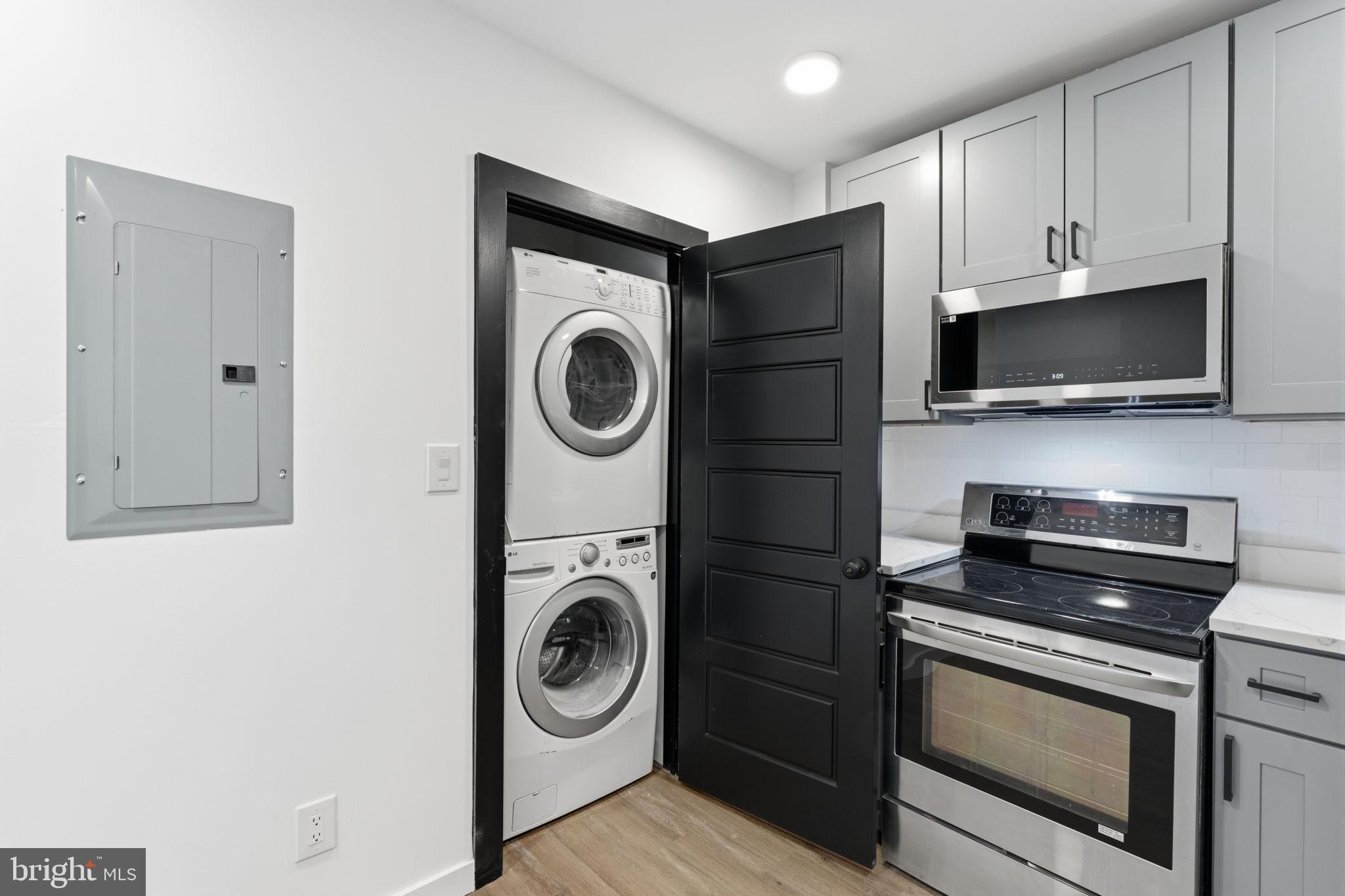 6508 Wheeler Street Philadelphia, PA 19142 - Photo 22 of 30 a kitchen with a stove and a microwave