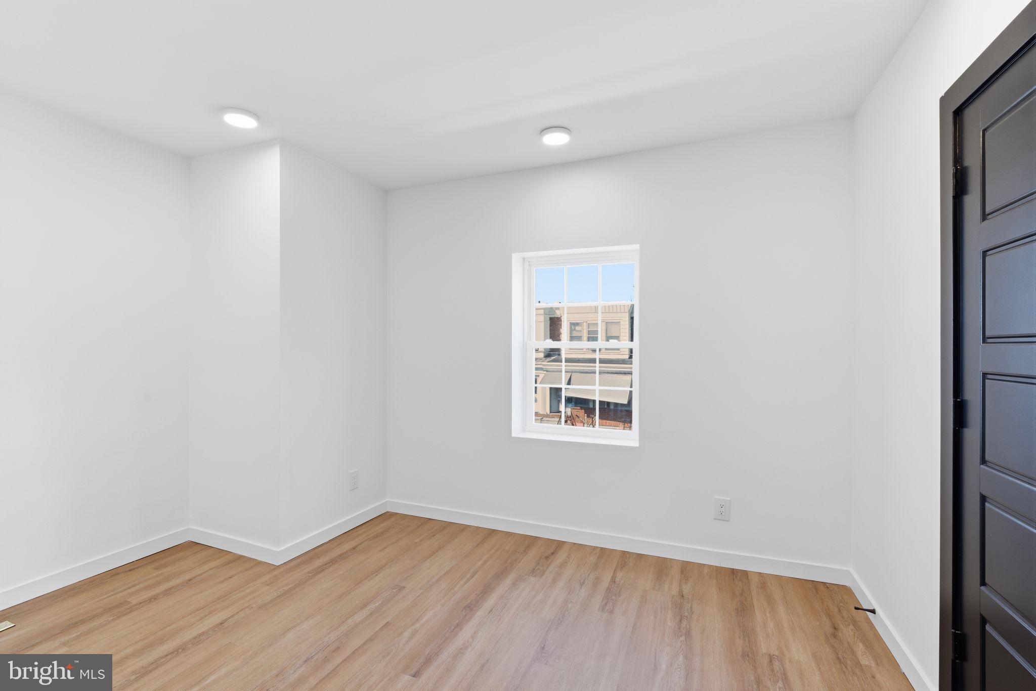 6508 Wheeler Street Philadelphia, PA 19142 - Photo 23 of 30 an empty room with wooden floor and windows