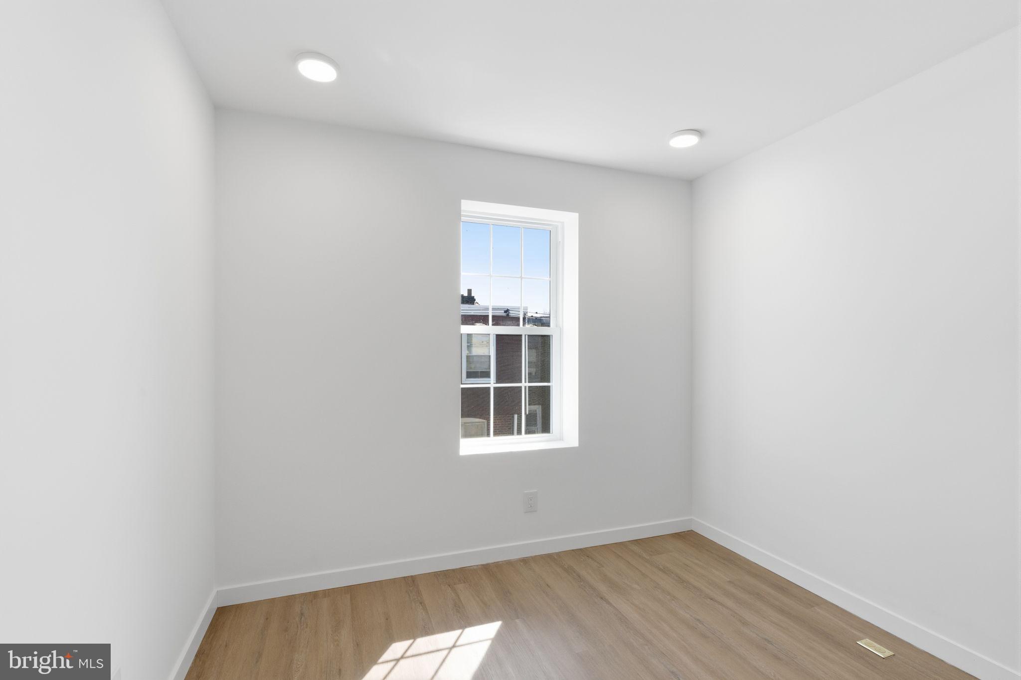 6508 Wheeler Street Philadelphia, PA 19142 - Photo 25 of 30 a view of an empty room with wooden floor and a window