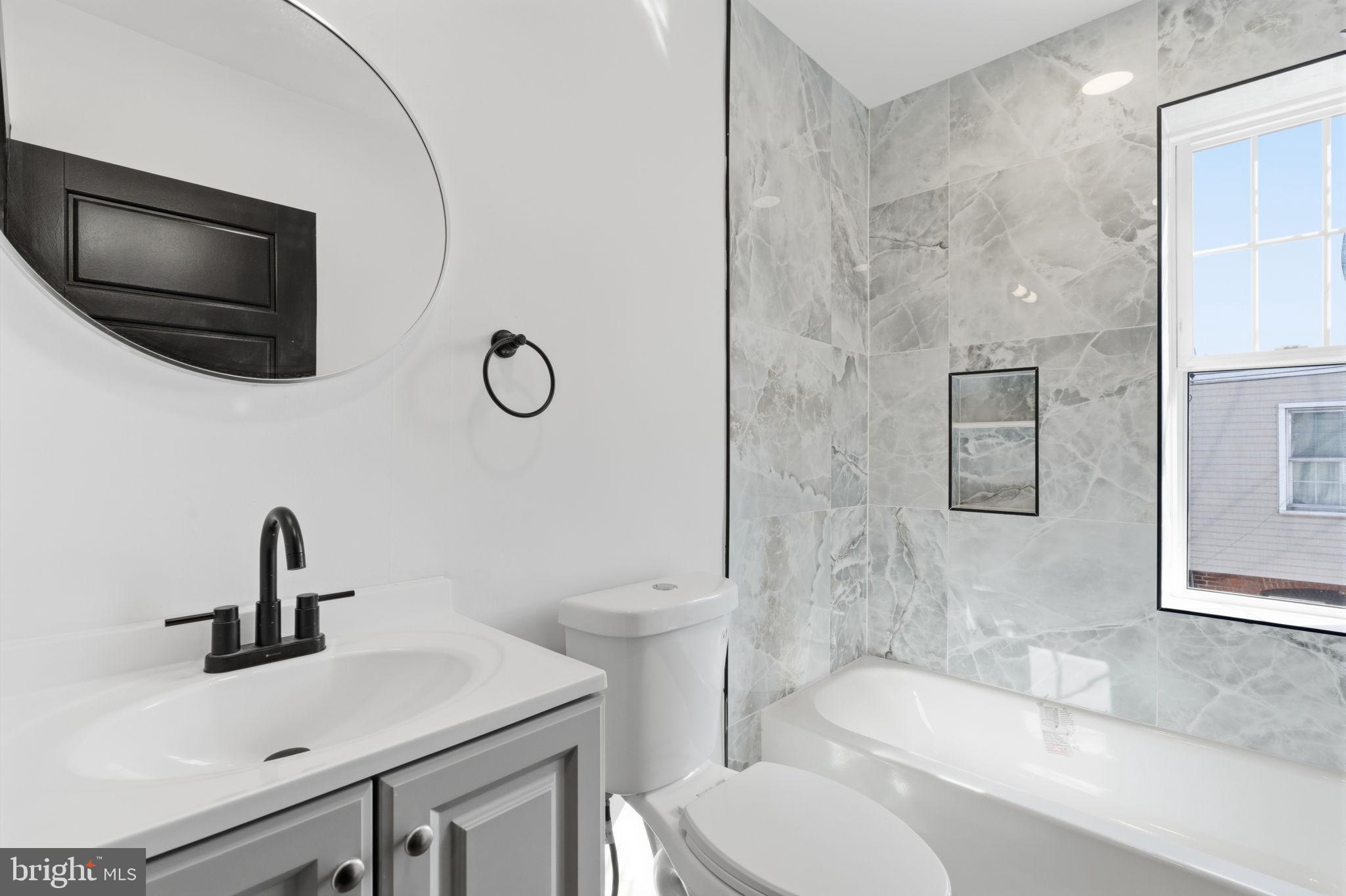 6508 Wheeler Street Philadelphia, PA 19142 - Photo 27 of 30 a bathroom with a sink a toilet and bathtub