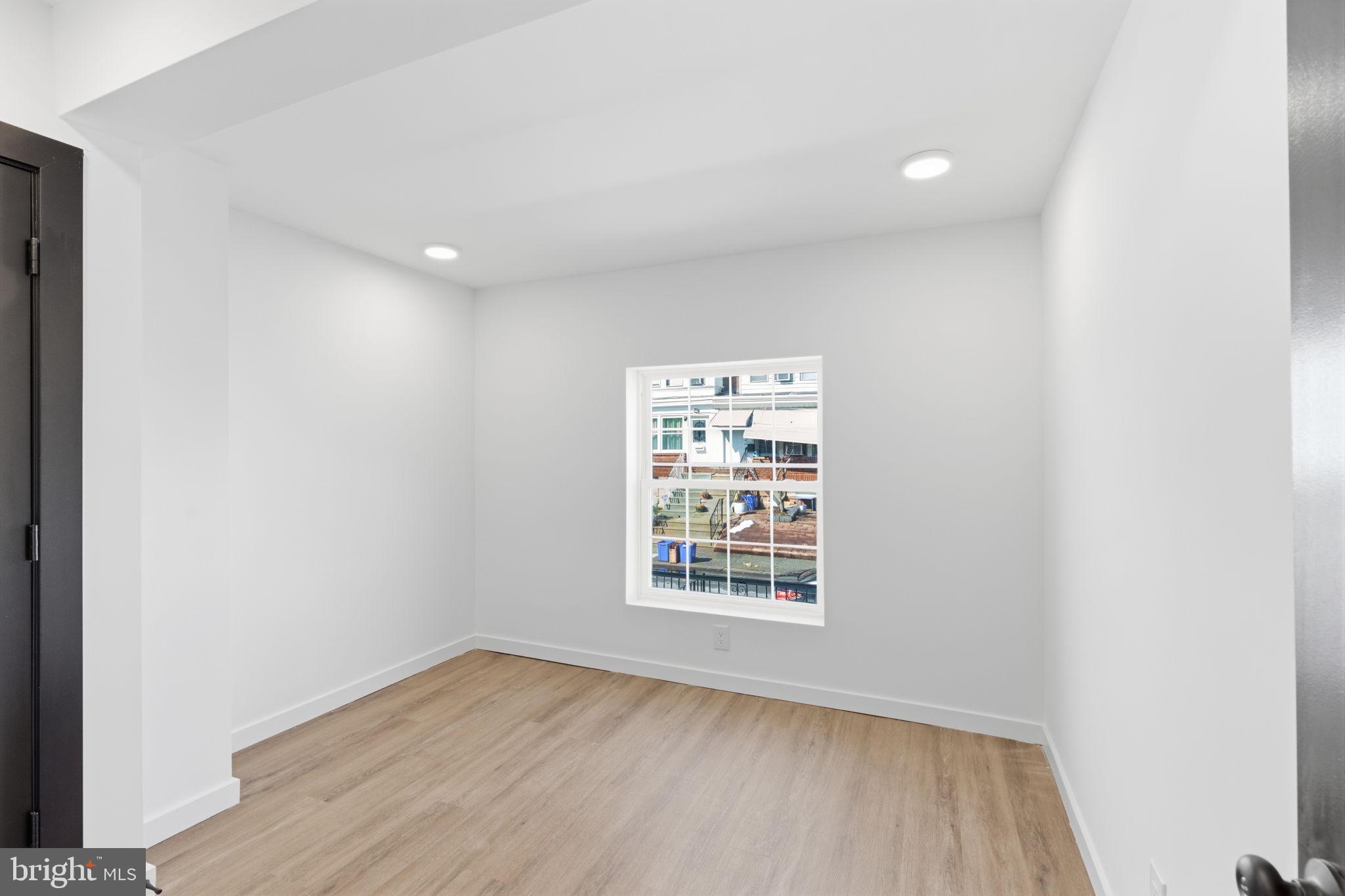 6508 Wheeler Street Philadelphia, PA 19142 - Photo 7 of 30 an empty room with wooden floor and windows