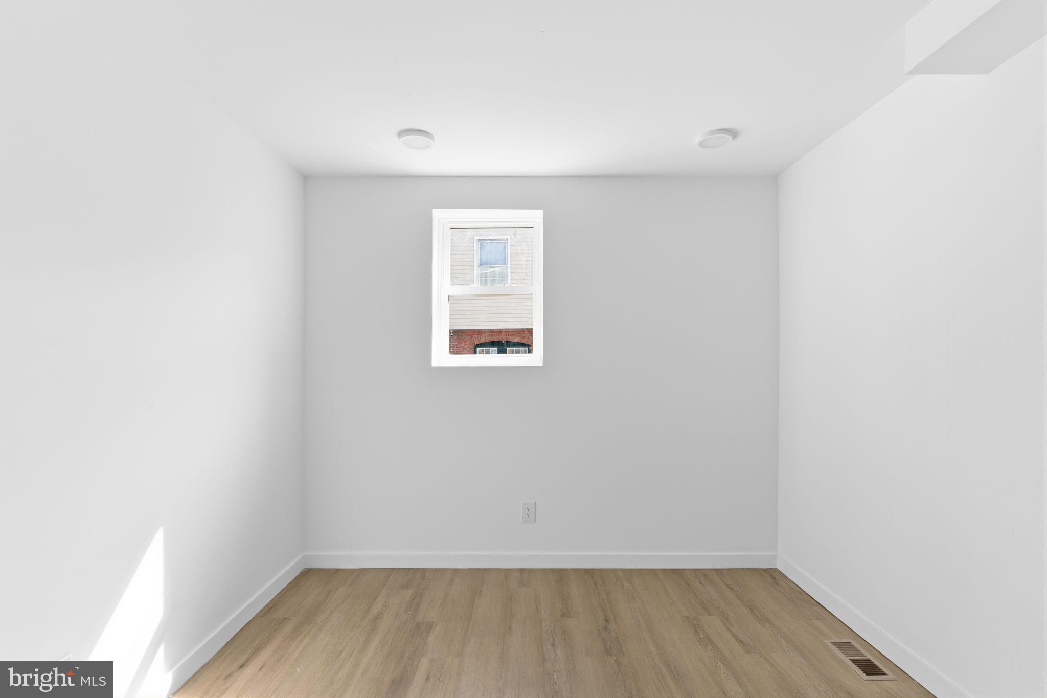6508 Wheeler Street Philadelphia, PA 19142 - Photo 9 of 30 a view of an empty room with wooden floor and a window