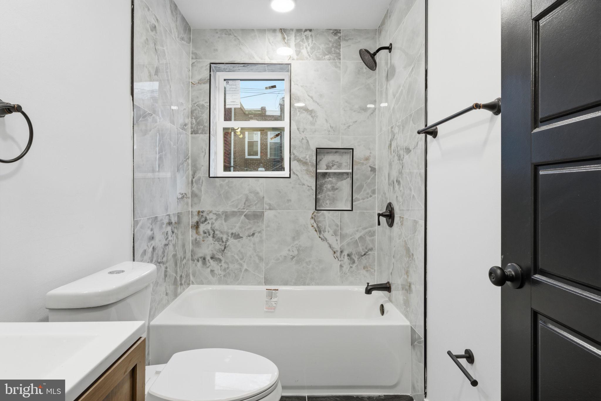 6508 Wheeler Street Philadelphia, PA 19142 - Photo 10 of 30 a bathroom with a toilet and a bathtub