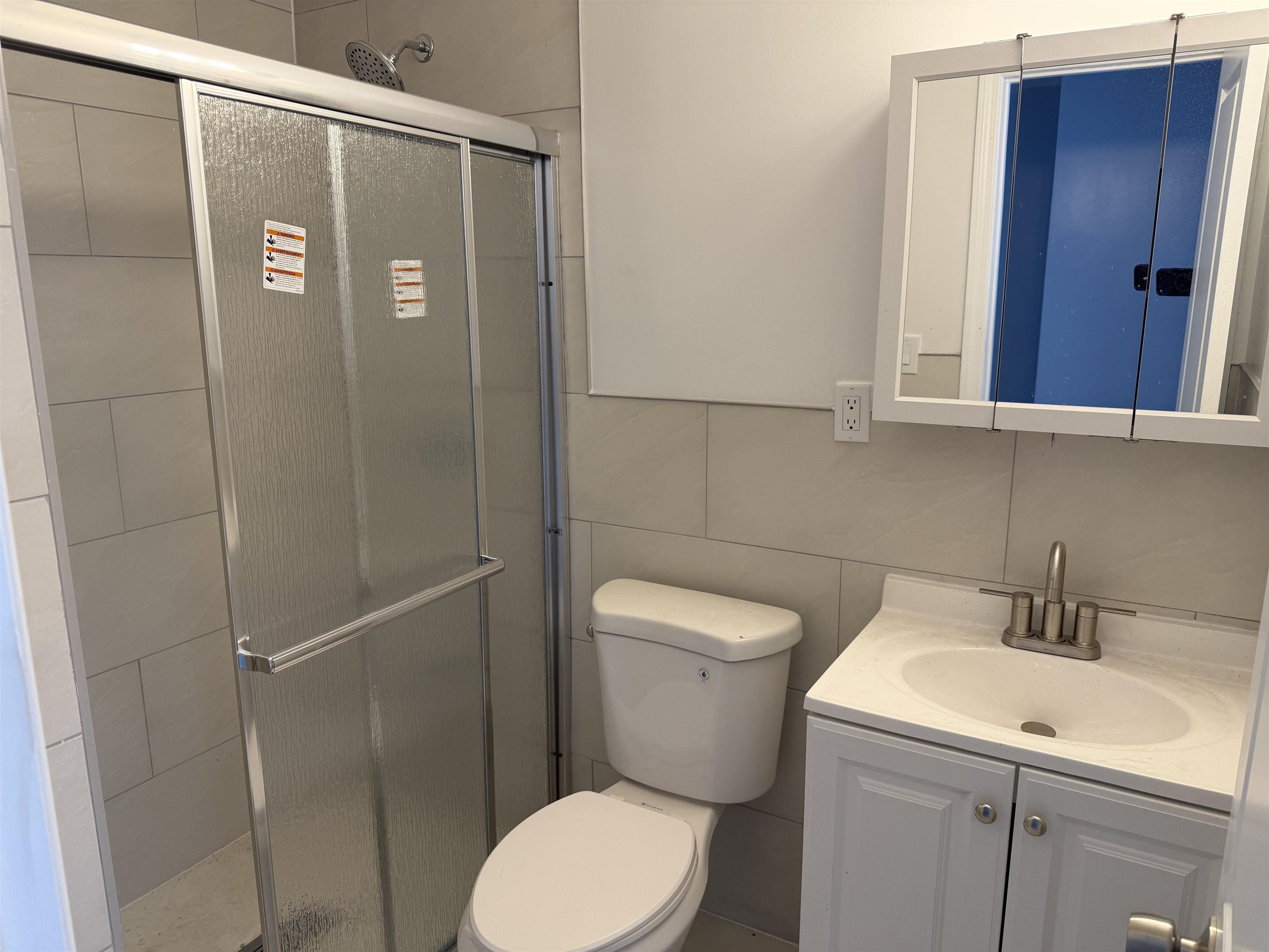 419 4th Street, Unit 1 Union City, NJ 07087 - Photo 16 of 20 a bathroom with a toilet a sink and shower