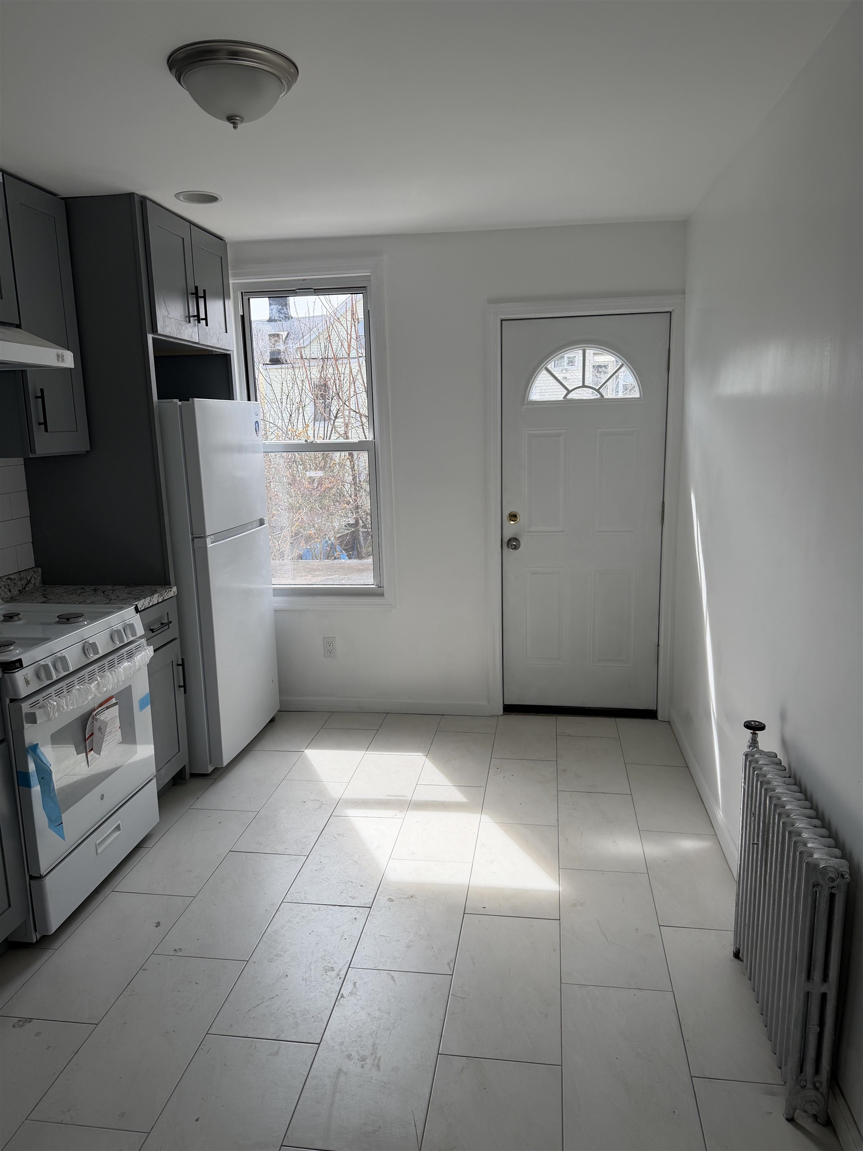 419 4th Street, Unit 1 Union City, NJ 07087 - Photo 2 of 20 a view of kitchen with windows and refrigerator