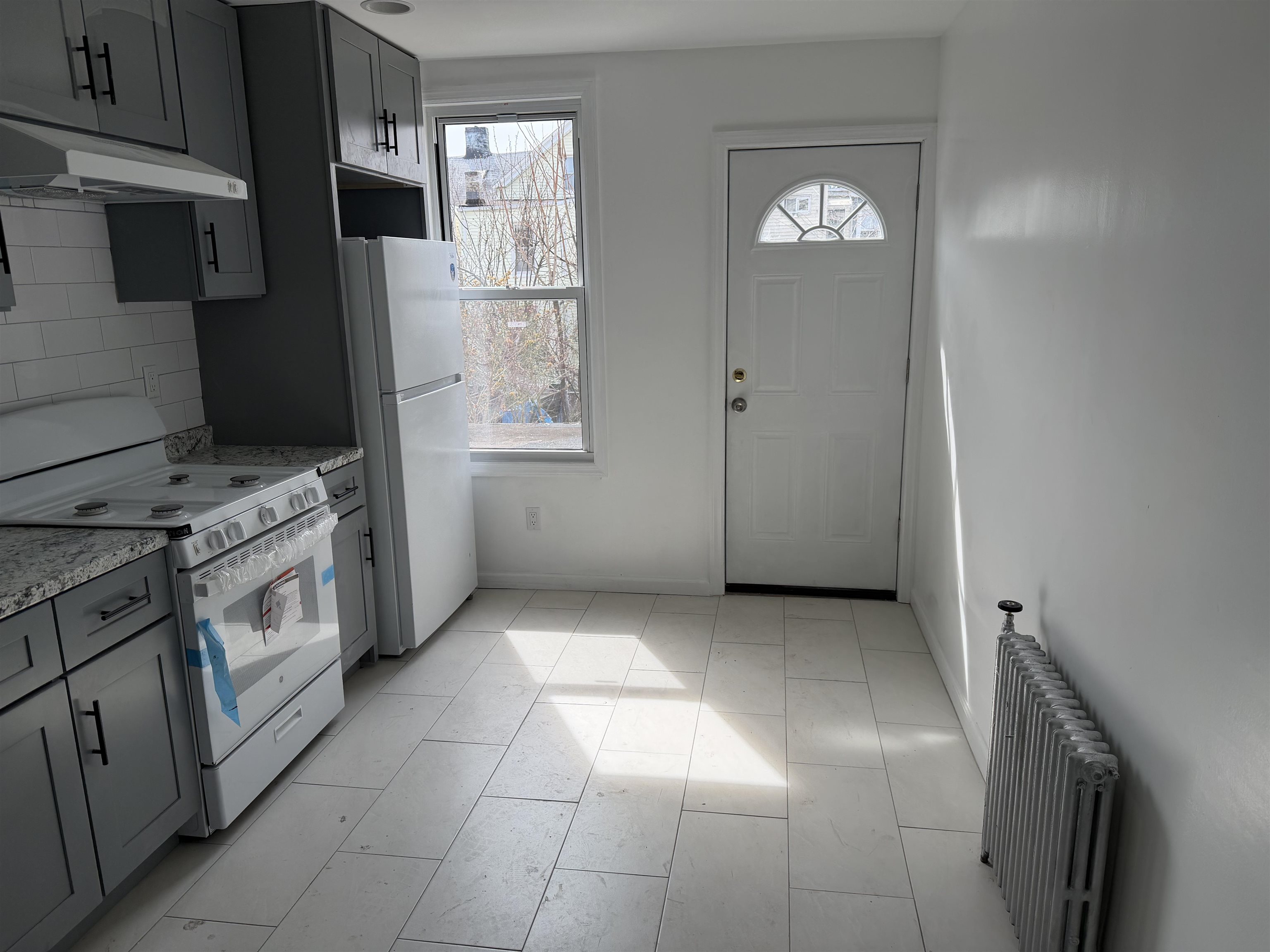 419 4th Street, Unit 1 Union City, NJ 07087 - Photo 3 of 20 a view of a kitchen with washer and dryer