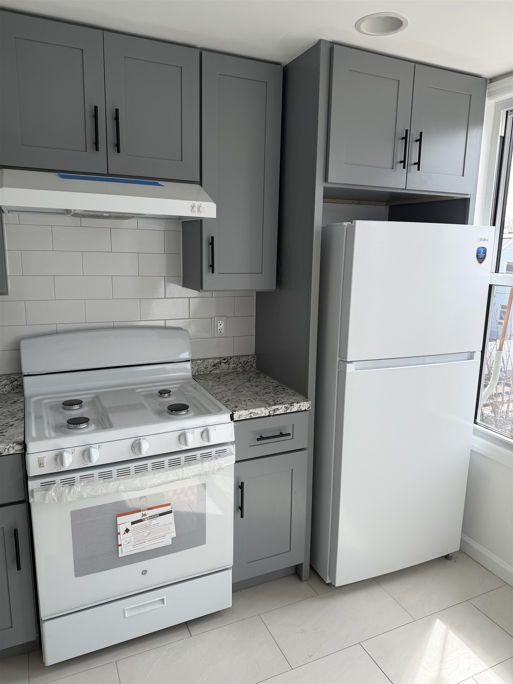 419 4th Street, Unit 1 Union City, NJ 07087 - Photo 9 of 20 a kitchen with a stove top oven and refrigerator